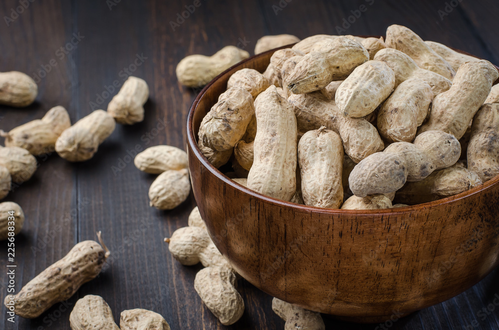 Peanuts in the peel on a dark background. Peanuts in the peel on a dark background.