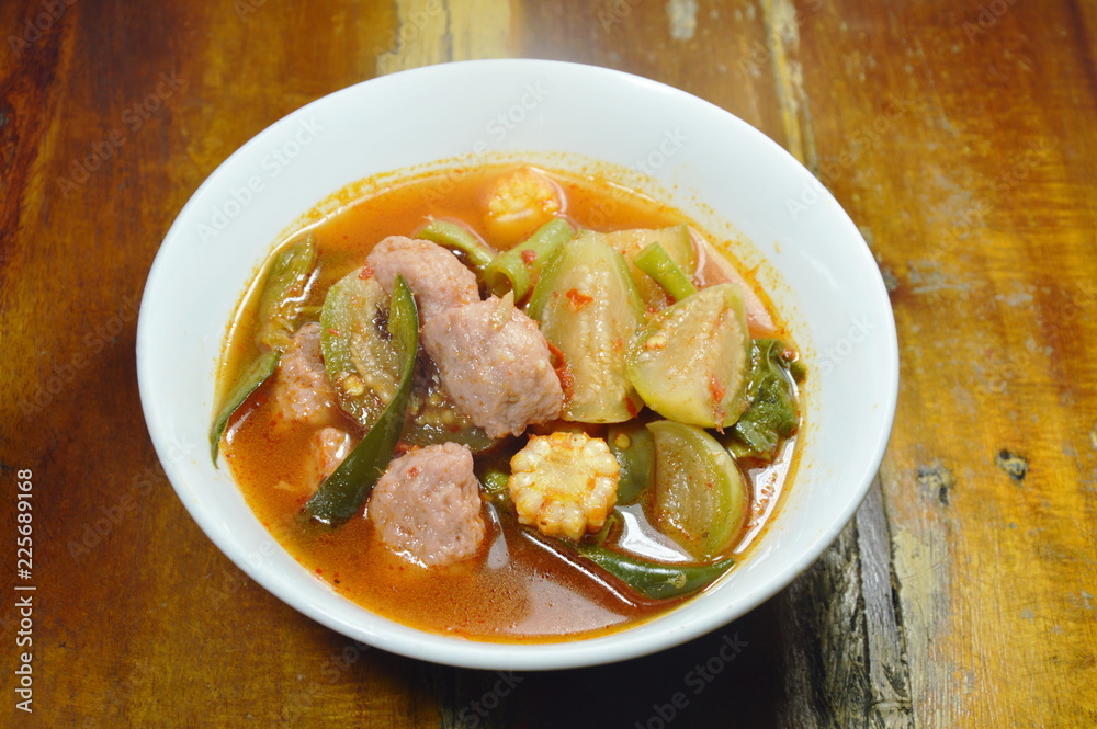 spicy fish ball with mixed vegetable in red curry soup on bowl spicy fish ball with mixed vegetable in red curry soup on bowl