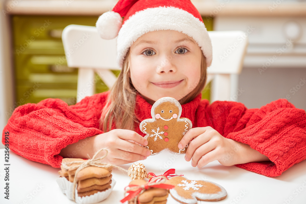 Beautiful girl child plays with ginger cookies. Concept of Christmas, New year Beautiful girl child plays with ginger cookies. Concept of Christmas, New year