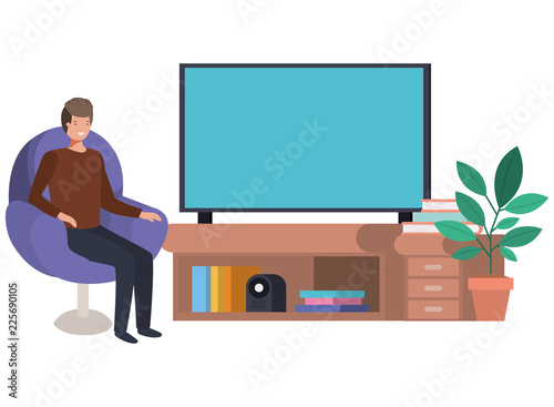 young man seated in the sofa watching tv