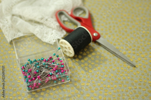 sewing accessories on silk background.