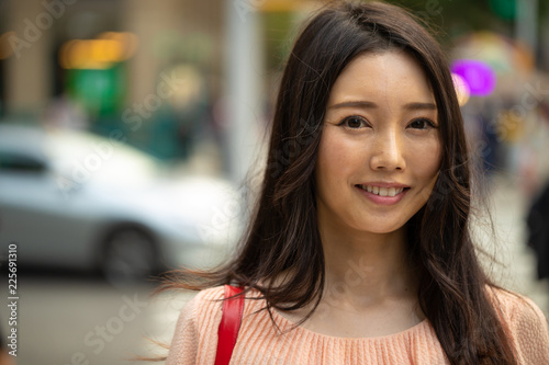 Asian woman in city smile happy face portrait