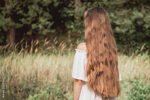 young girl european hipster with long and lovely hair looks at the forest, boho style, look back Summer and freedom concept. © Igor