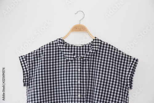 Small scott colour blouse is clothes hanger on white background.