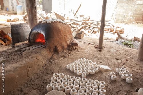 Traditional West African Ghanaian Krobo glass beads factory. Made from recycled glass bottles grinded into fine powder baked in clay molds in a termite clay oven.  Location Dowdowa - GHANA 