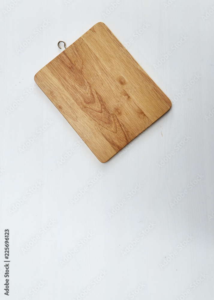 Fototapeta premium Wooden cutting board on white table