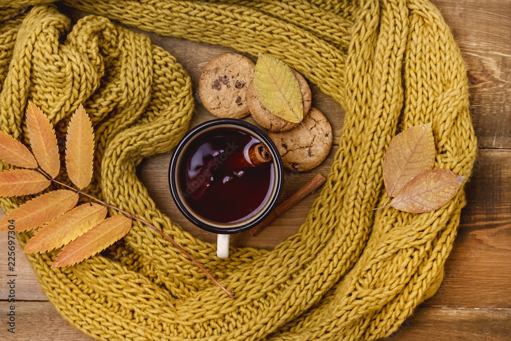 Mug or Cup of Hot Berry Tea With Yellow Warm Knitted Scarf Autumn Maple Leaves Wooden Background Top View Flat Lay Autumn Cold season