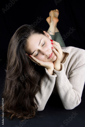 beautiful young woman lying down with cachemere beige sweater photo