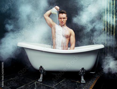  young man taking a bath with milk
