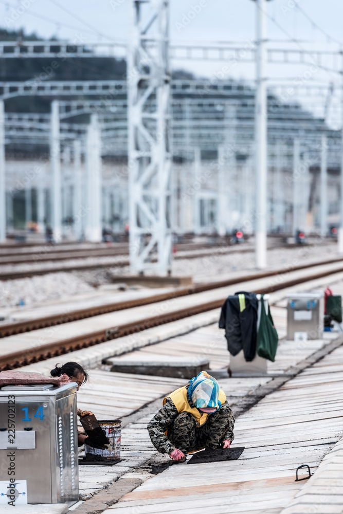 Railway workers maintain high-speed railway tracks at a high-speed railway station in kunming, southwest China's yunnan province, sept 28, 2018