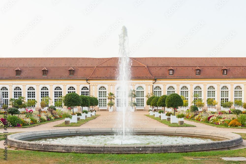 The main building of the Orangery and the fountain in the Central Park of Ansbach, Bavaria Germany