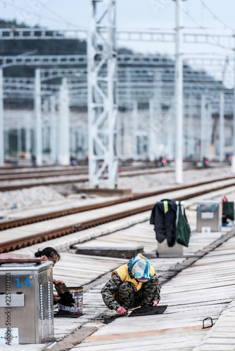 Railway workers maintain high-speed railway tracks at a high-speed railway station in kunming, southwest China's yunnan province, sept 28, 2018