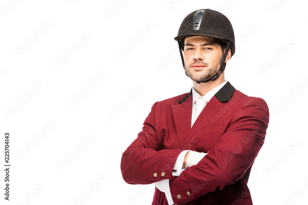 handsome young horseman in uniform and helmet looking at camera with crossed arms isolated on white handsome young horseman in uniform and helmet looking at camera with crossed arms isolated on white