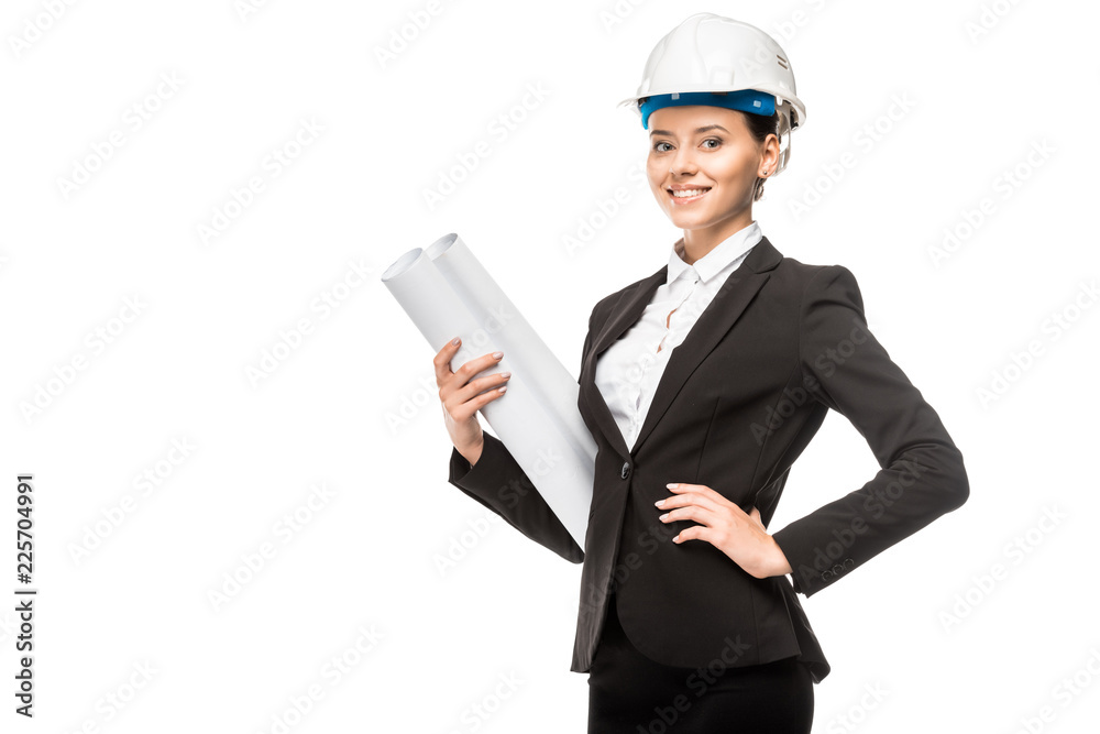 beautiful young female architect in helmet and suit holding blueprints and looking at camera isolated on white beautiful young female architect in helmet and suit holding blueprints and looking at camera isolated on white