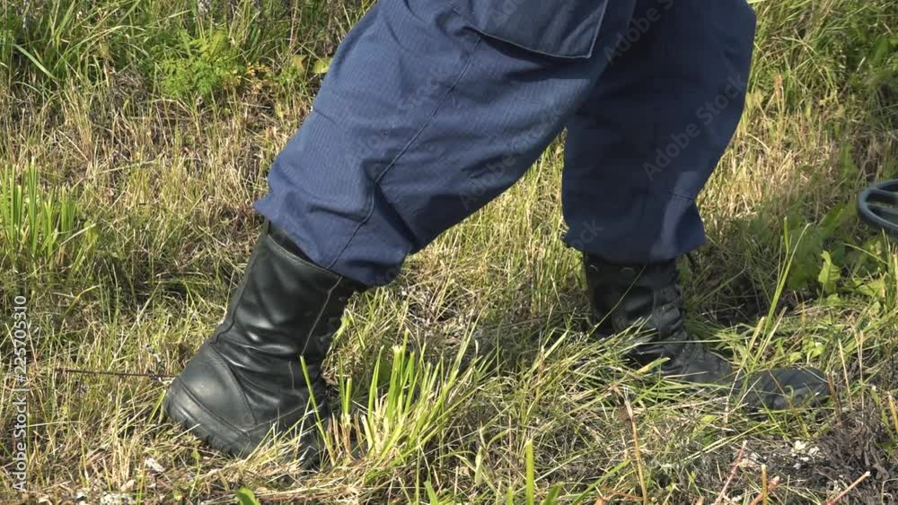 Man with a metal detector scans the ground Man with a metal detector scans the ground