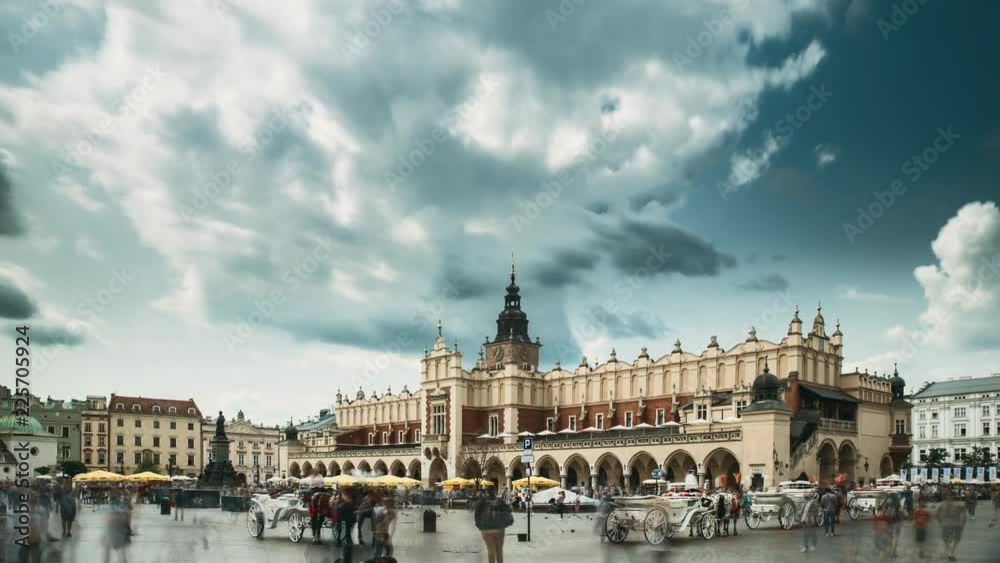 Krakow, Poland. Main Market Square In Cloudy Summer Day. Famous Landmark. Unesco World Heritage Site Krakow, Poland. Main Market Square In Cloudy Summer Day. Famous Landmark. Unesco World Heritage Site