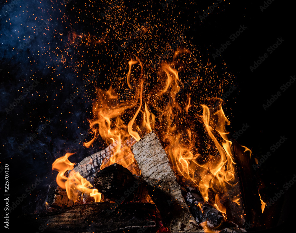 Burning wooden logs in fire, campfire on black - obrazy, fototapety, plakaty 