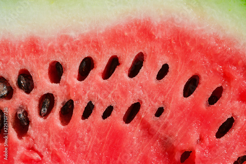 Background of watermelon pulp on slice, top view close-up, food texture, 
