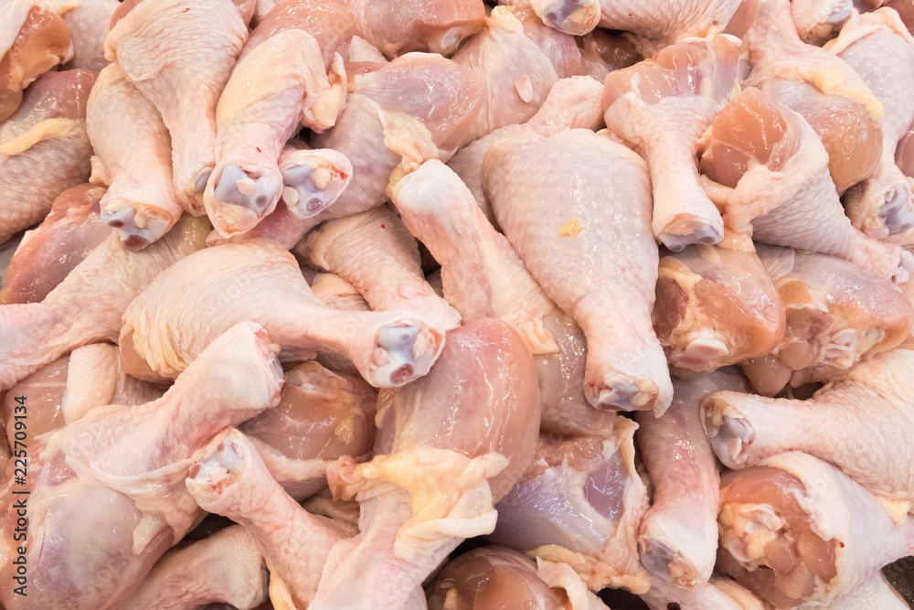 Piles of raw chicken drumstick in supermarket as background Piles of raw chicken drumstick in supermarket as background