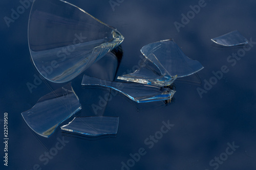 Wallpaper Mural broken glasses containing danger on blue background Torontodigital.ca