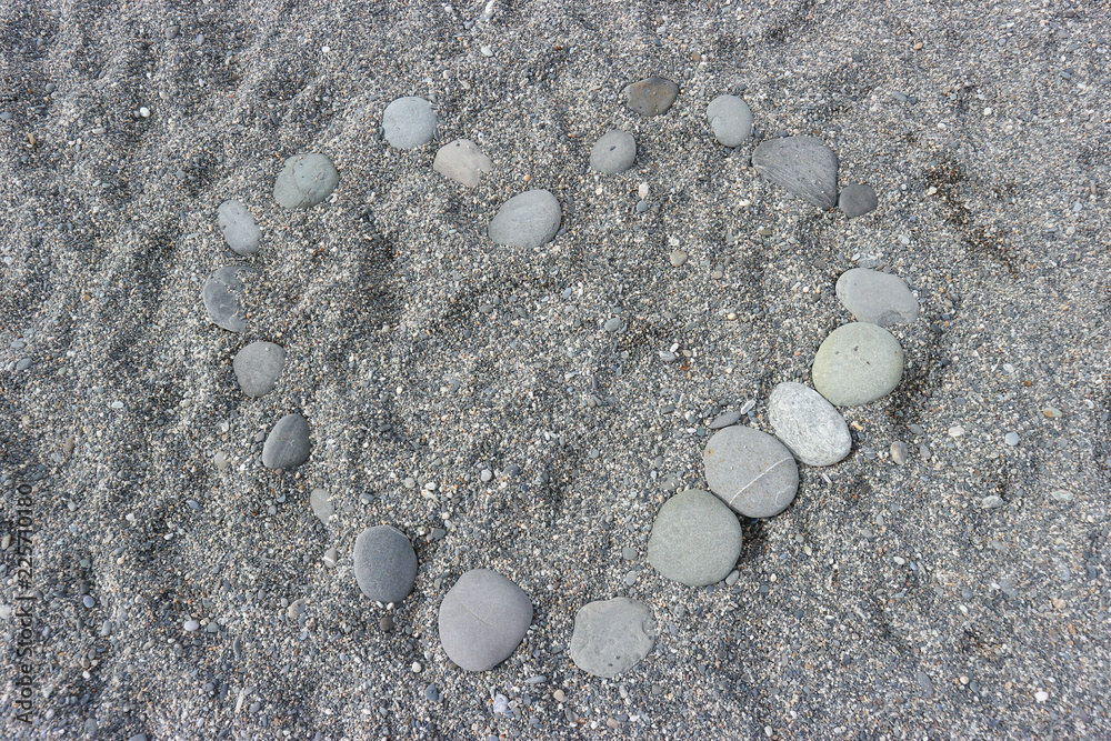 sorted stone in heart shape on the sand. sorted stone in heart shape on the sand.