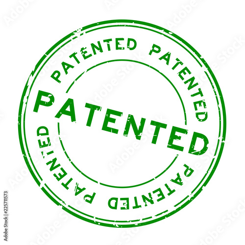 Grunge green patented word round rubber seal stamp on white background