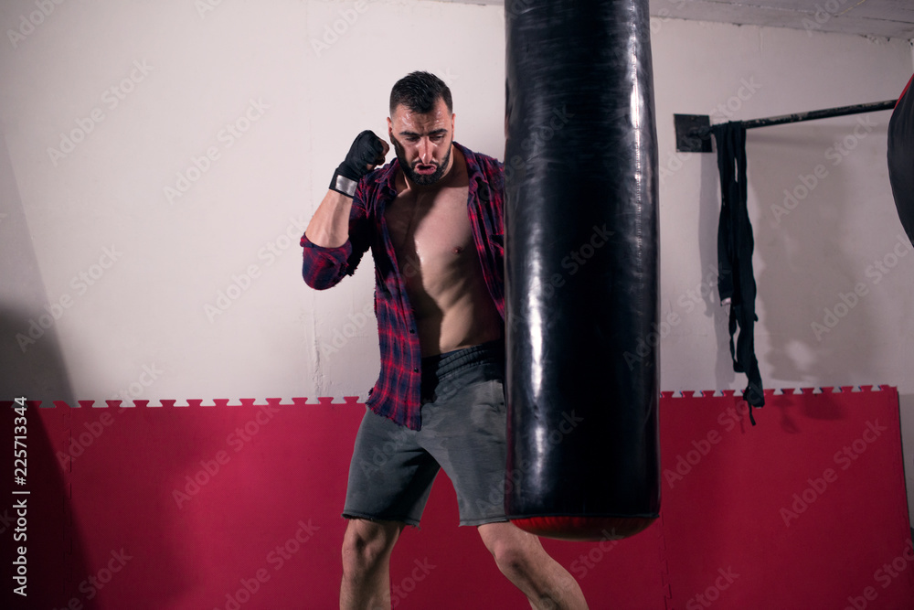 Muscular man throwing a fierce and powerful punch