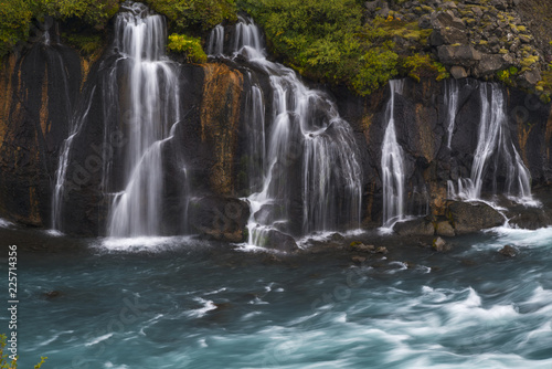 Waterfall flowing into blue river