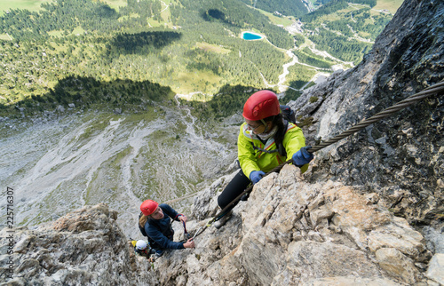 two young attractive female mountain climber in the Dolomites of Italy with a great view