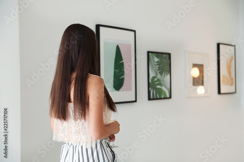 Young woman at exhibition in art gallery