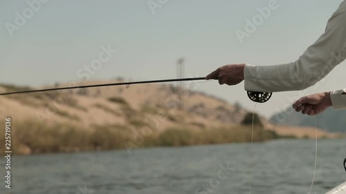 Close Up of Fly Fisherman Stripping Line on Fly Rod