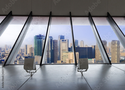 Canvas Print Landscape of tokyo city skyline in Aerial view with skyscraper and blue sky with cloudy sky background from clear glass window door frame interior room, in Tokyo metropolis, Japan