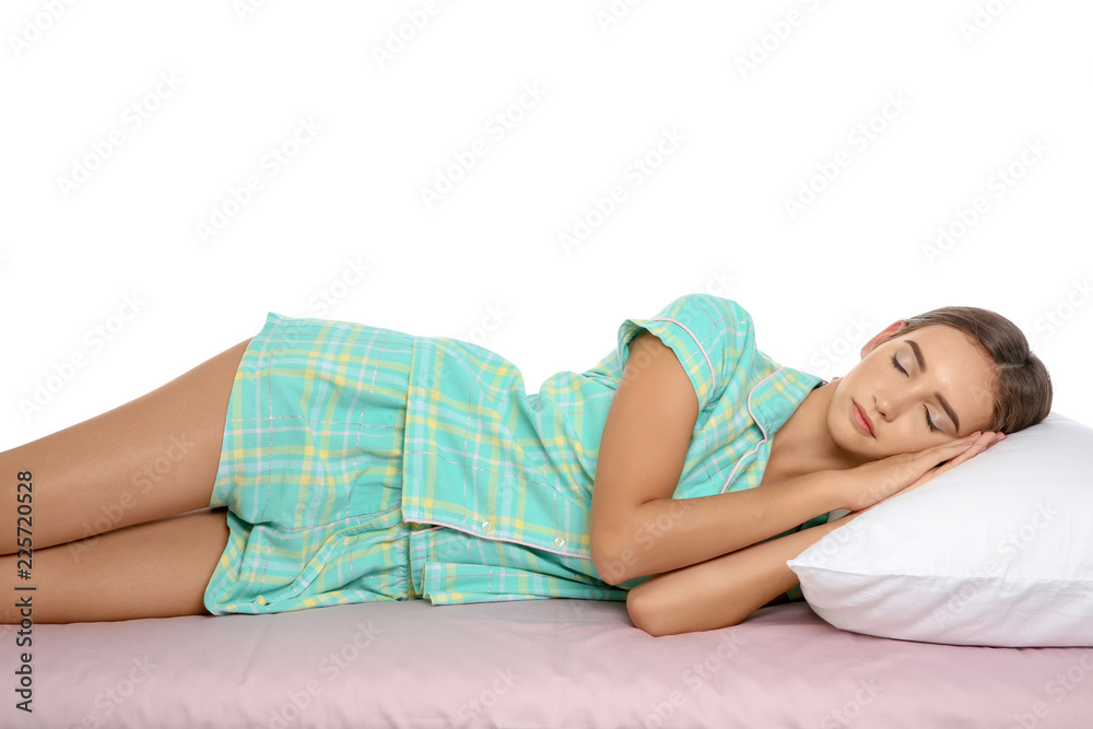 Naklejka premium Beautiful teen girl sleeping with comfortable pillow on bed against white background