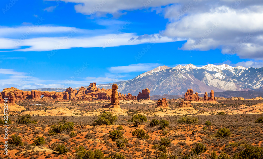 Desert Landscape with La Sal Mountains and Window Arch in Arches National Park