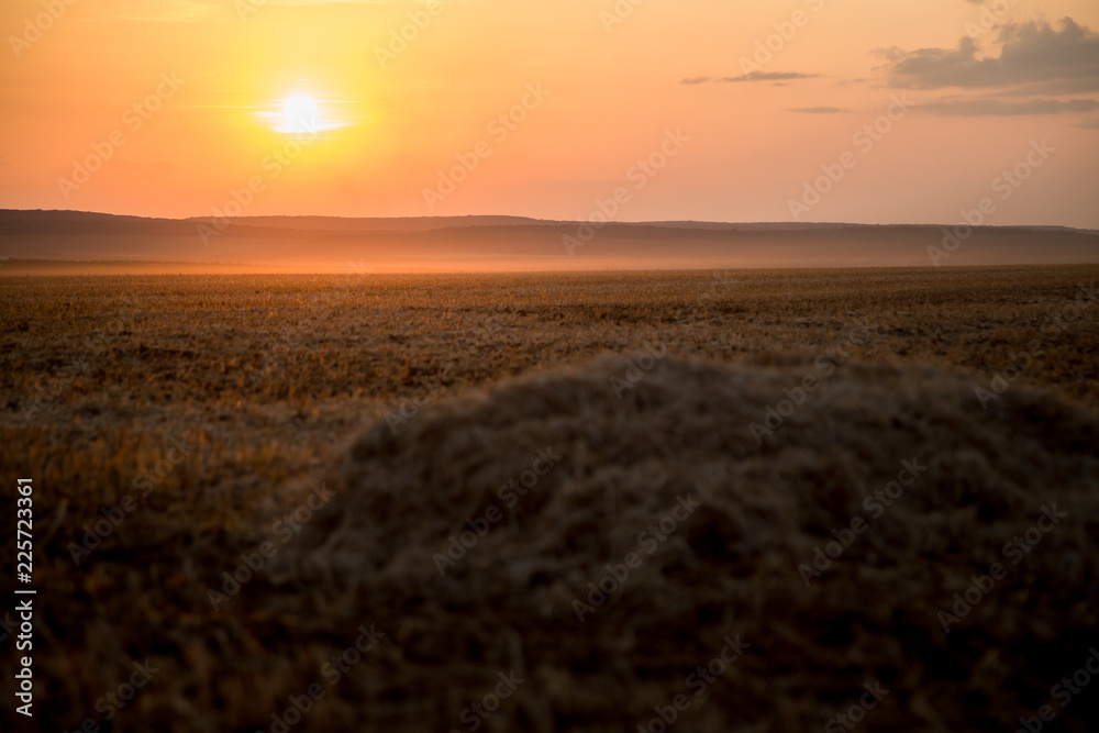 A beautiful Golden Sunset, over a cut hay field, on a quiet Country Evening in Ukraine