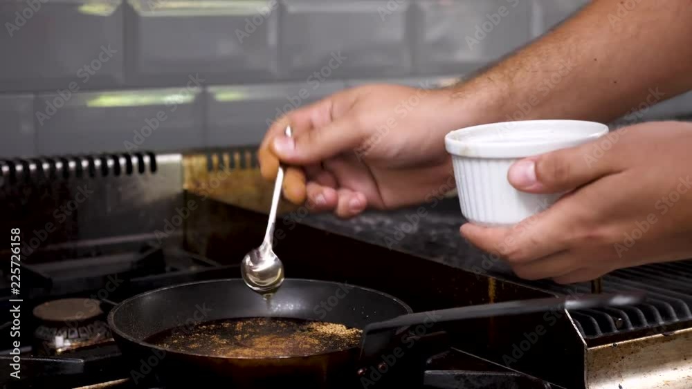 Cook in restaurant kitchen preparing a souce for clients. Close up footage Cook in restaurant kitchen preparing a souce for clients. Close up footage
