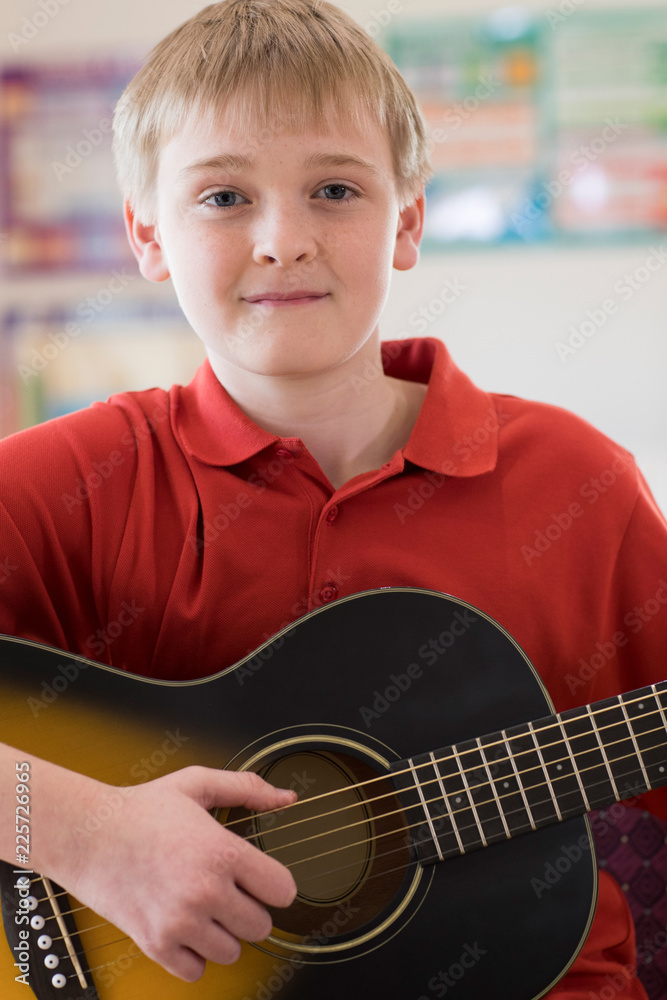 © Daisy Daisy - Portrait Of Male High School Pupil Playing Guitar
