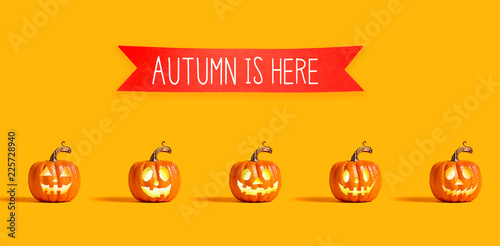 Autumn is here message with orange pumpkin lanterns with a red banner
