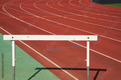 white wood training hurdle race on red running in sport stadium track background © bidala