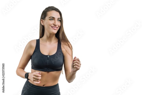 Young woman runner in black sportswear, isolated on white background, copy space © Valerii Honcharuk