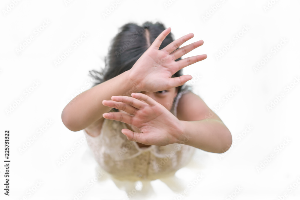 Fototapeta premium The little girl looked up at the sky and raised her hand for help. 