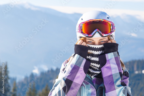 Blonde in helmet among mountains