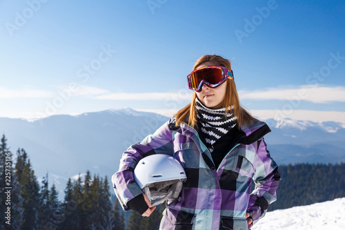 Skier girl on the background of high mountain Carpathians in Ukraine. Winter sport.