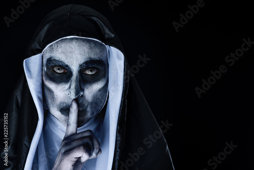 frightening evil nun asking for silence photo