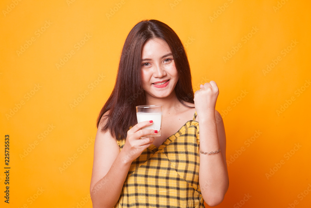 Healthy Asian woman drinking a glass of milk. Healthy Asian woman drinking a glass of milk.