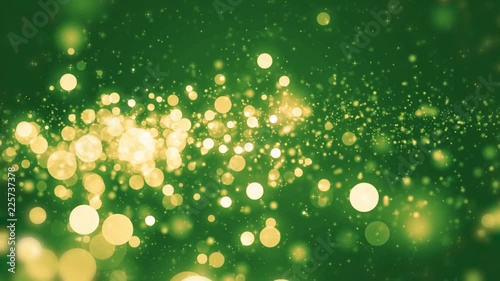 Green light shine particles bokeh, holiday concept. Christmas animated gold background with circles and stars. Space background. Screen green. Seamless loop.