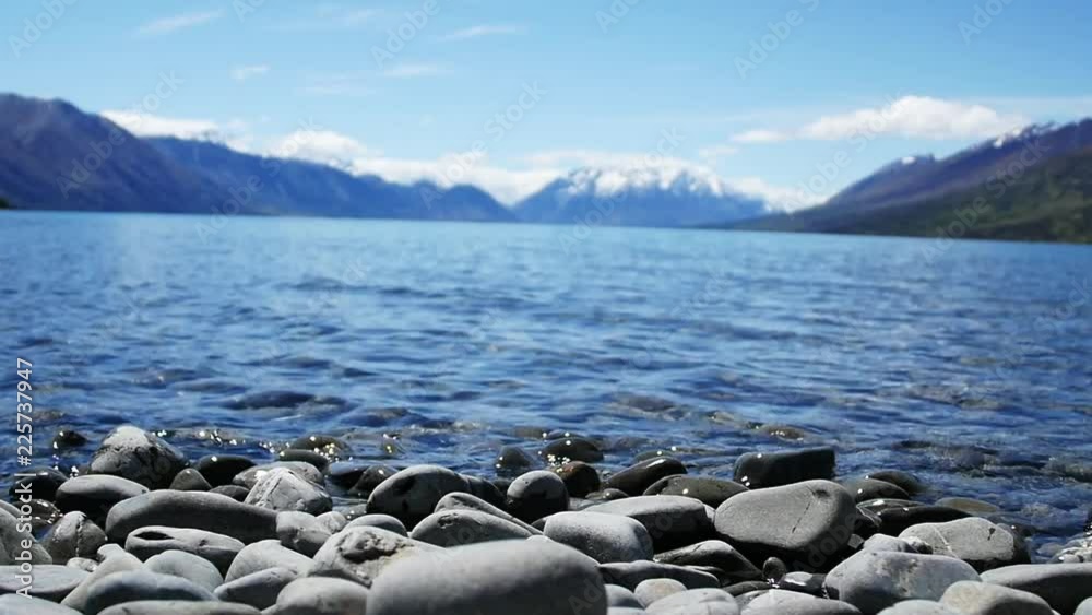 Loop of Low angle, scenic lake in New Zealand with mountains in background