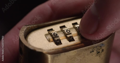 Loop of Person spins combination lock, close up. Loop 2 of 2.
