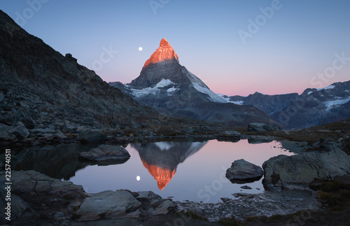 The famous Riffelsee and the Matterhorn, with the moon and the first sunlight shining on the mountaintop.