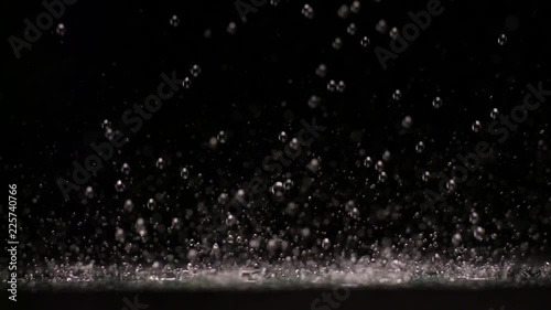 Loop of Water droplets, slow motion black background